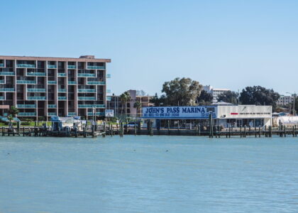 View of Madeira Beach condos from water showing Johns Pass Marina.