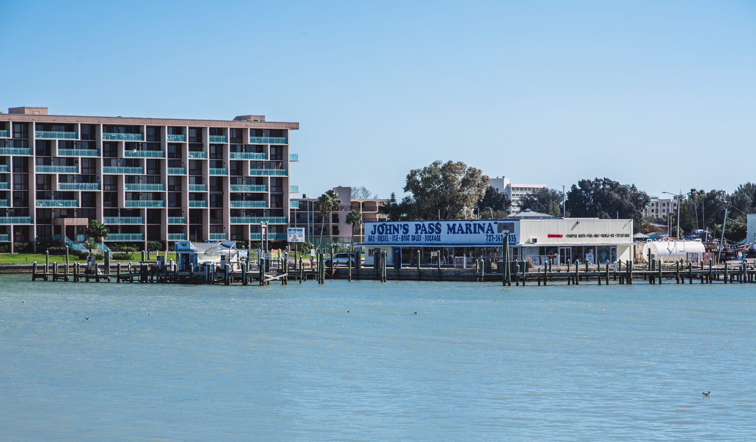 View of Madeira Beach condos from water showing Johns Pass Marina.